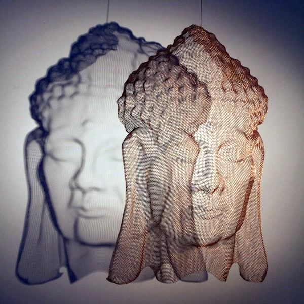Contemplation in a Buddha face portrait, copper bronzemesh