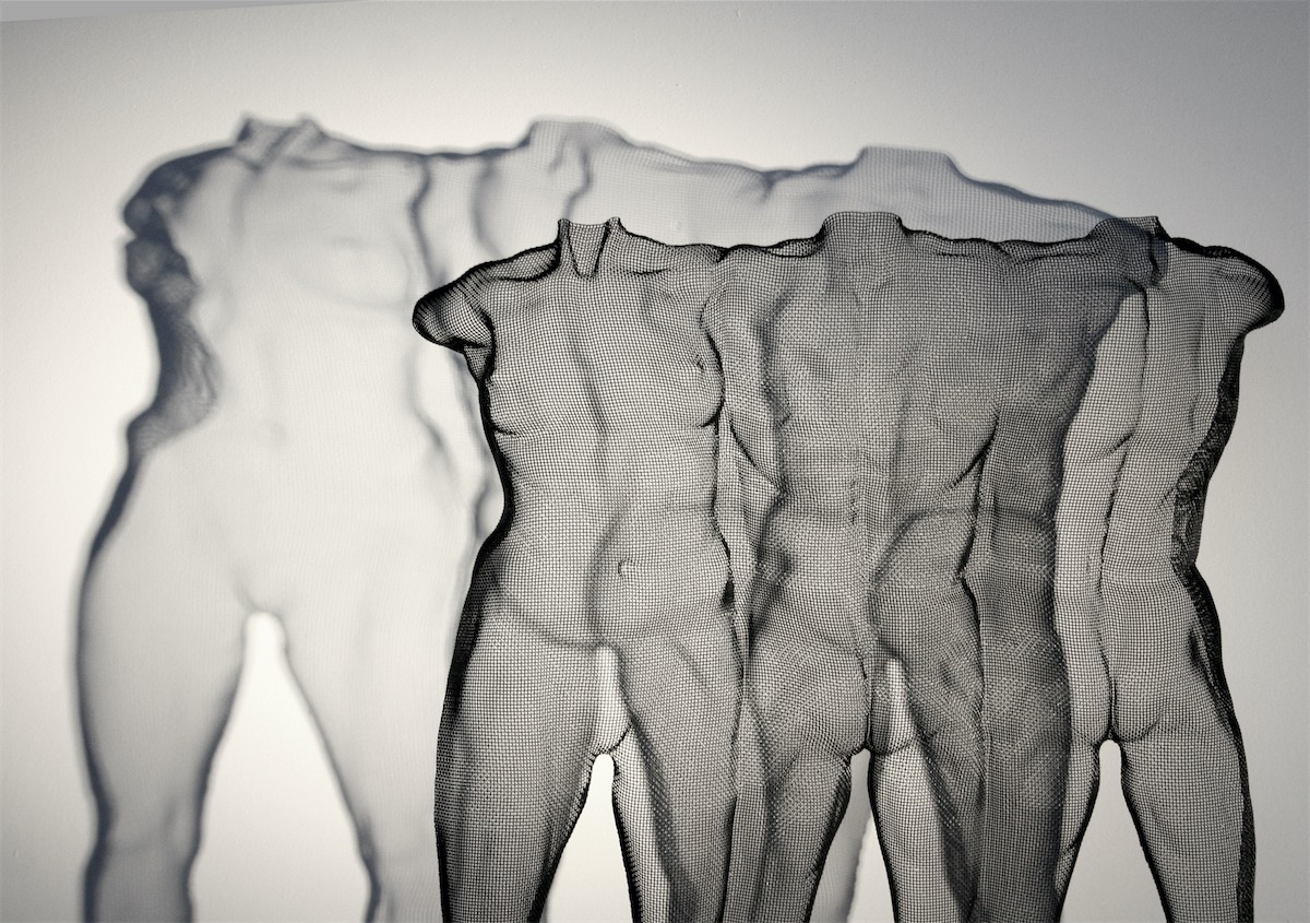 Shadows are reflected of a wire-mesh bodystudy of nude figures. Art by sculptor David Begbie