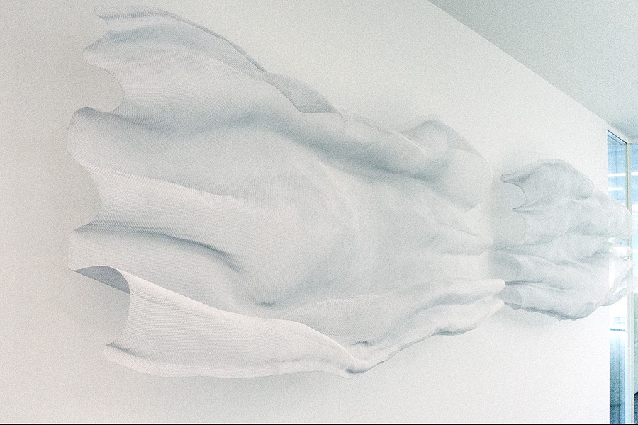 Wall-mounted sculpture composition at an office reception