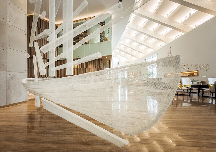 Commissioned large sculpture of a boat in white painted mesh - centrepiece of the hotel reception