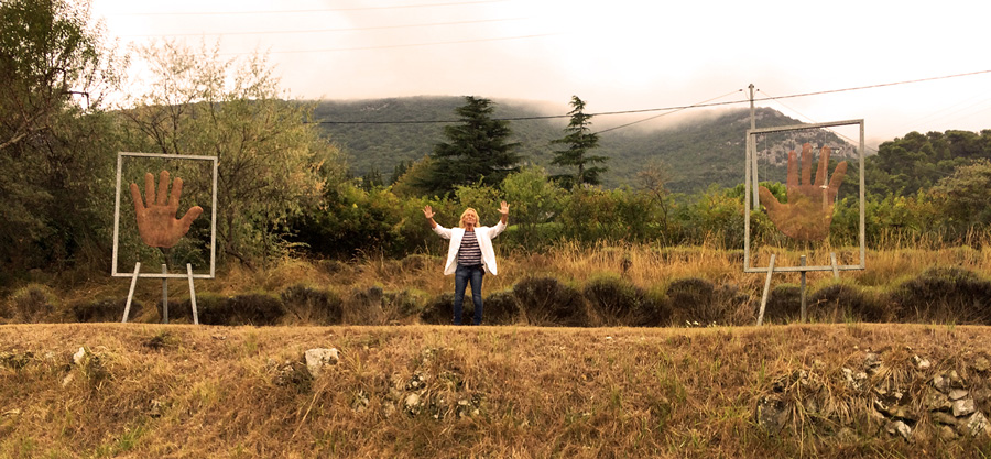 Mesh sculptures of two hands in landscape Southern France