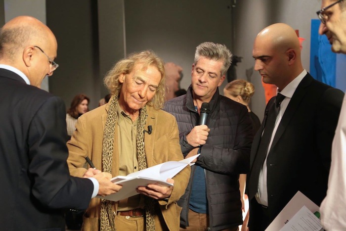 artist signing exhibition catalogue