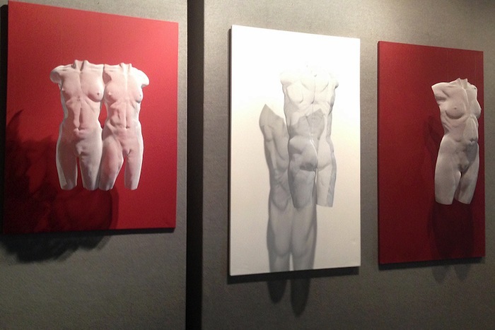 white wall-mounted wire-mesh sculptures