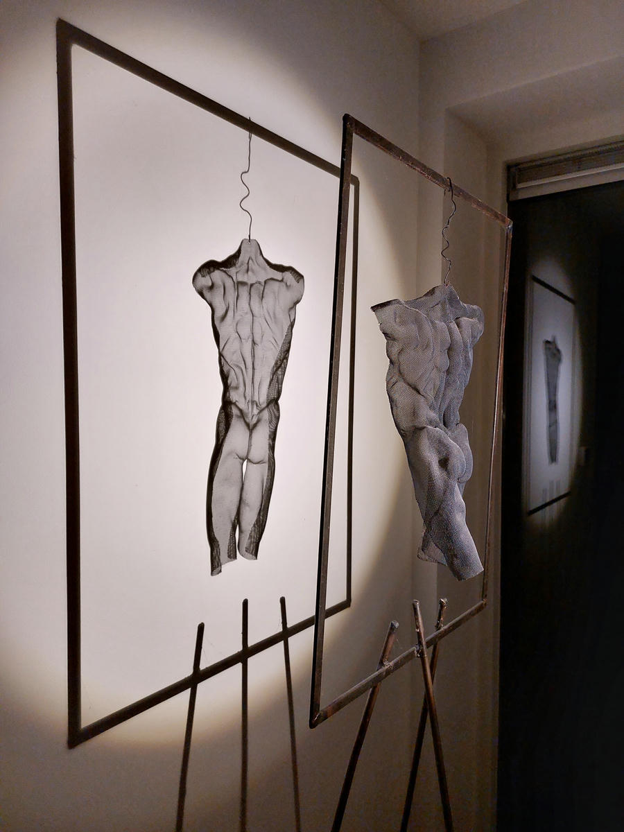 A black-painted steel frame as a suspension solution for a floating sculpture