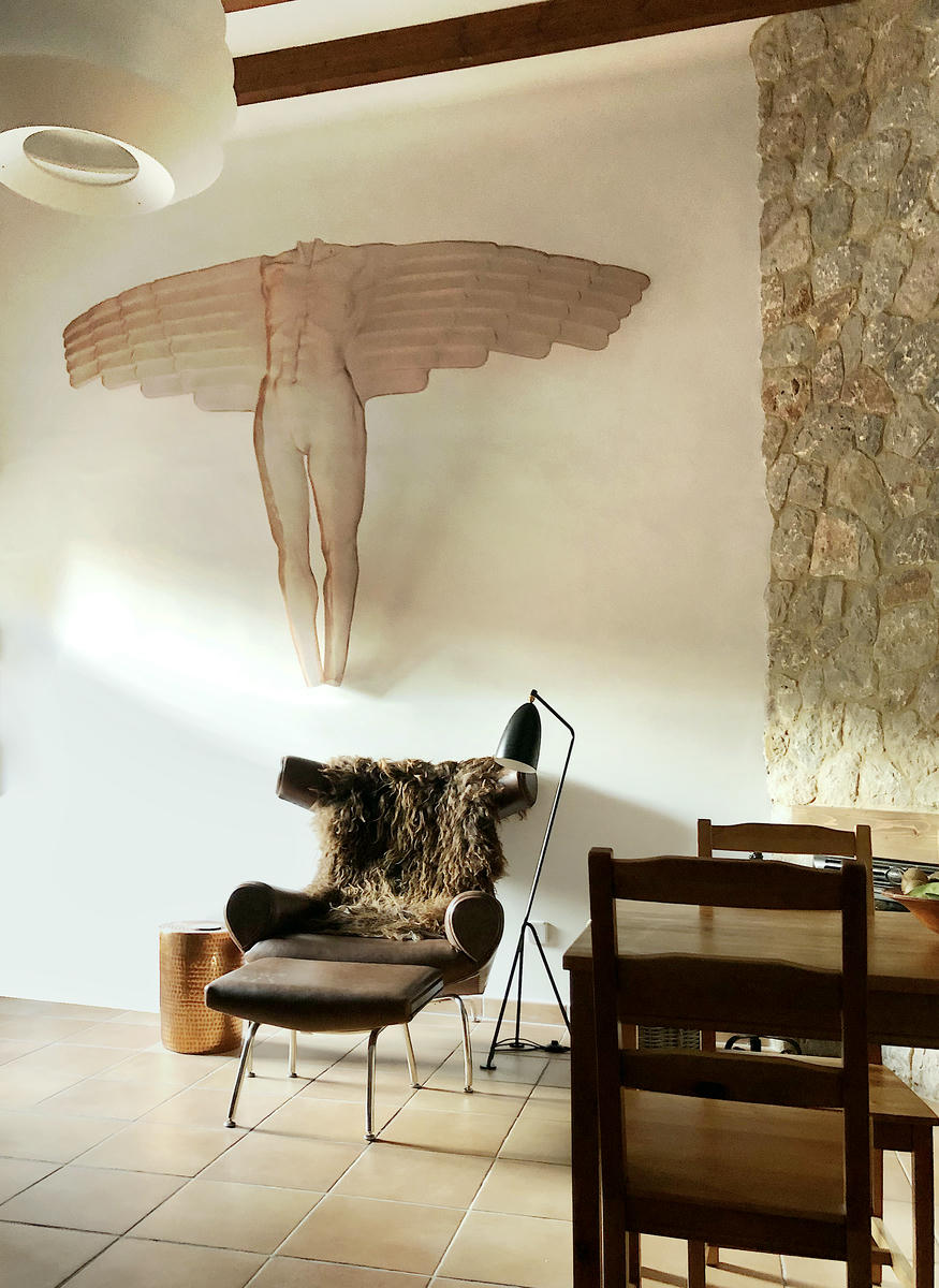Mallorca Ambience - rustic living room with a modern wall sculpture of an angel