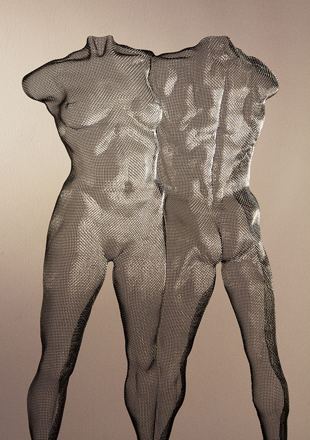 A sculpture of a woman and a man melted to a unique shape