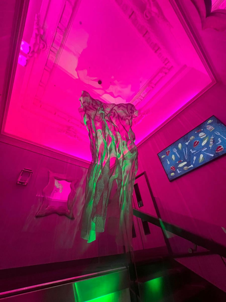 Large wire-mesh art as a center piece of an staircase