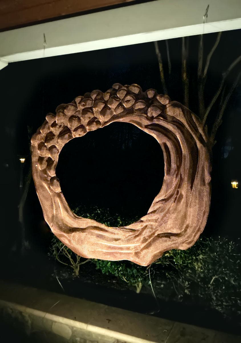 Night shot of a ransparent David Begbie sculpture in a private garden
