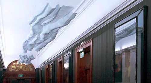 A hotel corridor with abstract wire-mesh sculptures