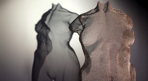 Detail of a rose-gold metallic sculpture of a nude girl sculpted by artist David Begbie