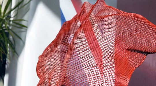 A red female figure sculpture filmed at the artist studio